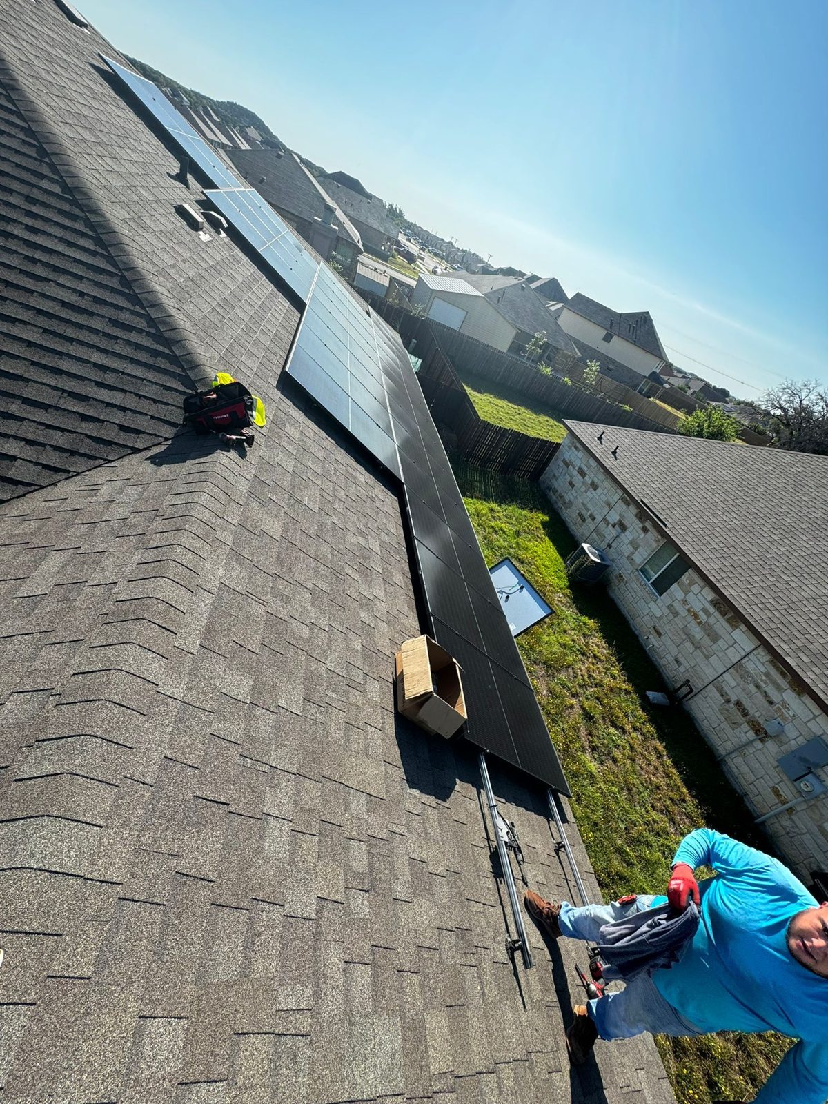 Crew installing panels on the residential roof, military veteran solar project