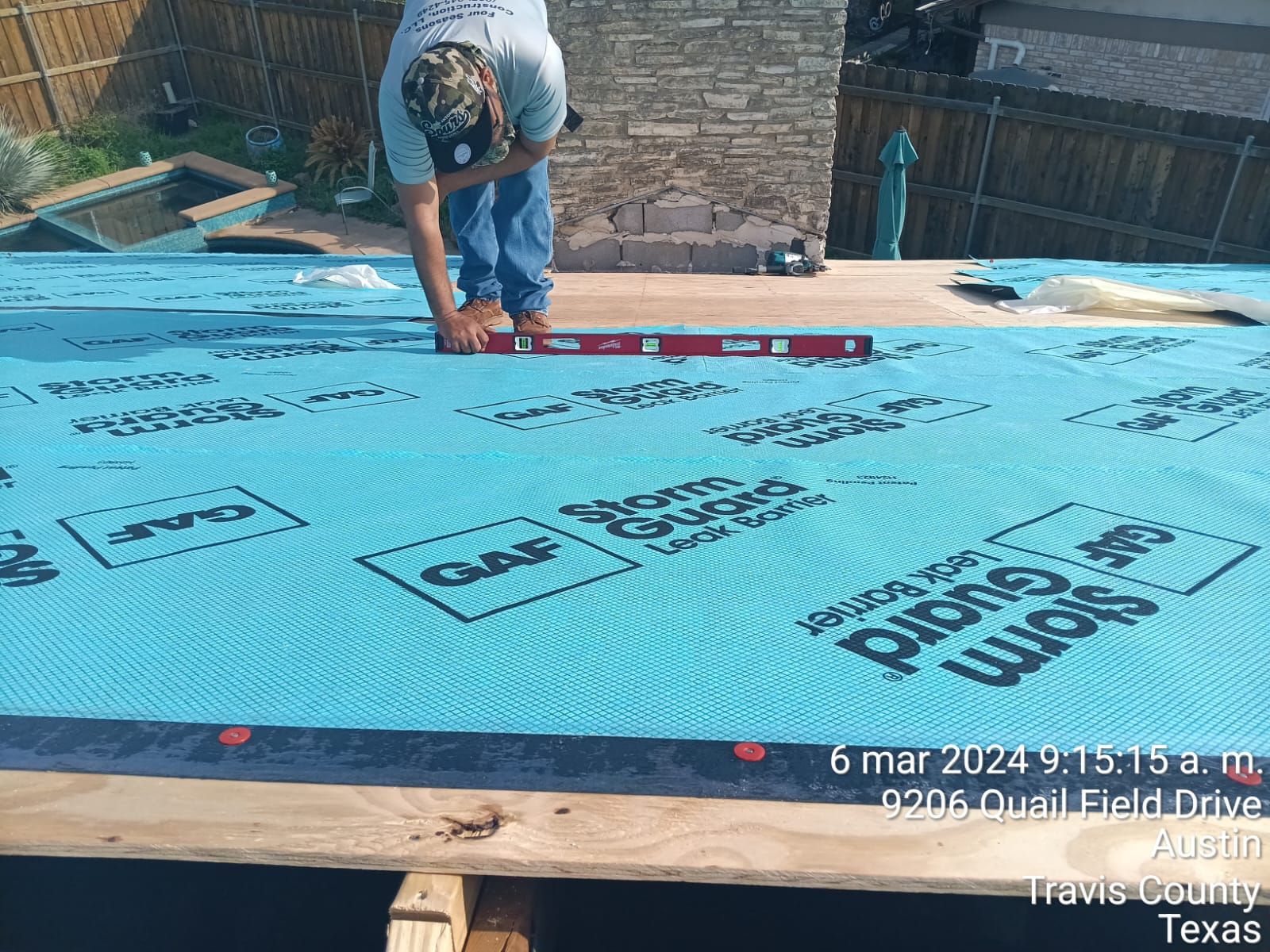Crew working on roof decking near a chimney, Gold Coast Roofing and Solar