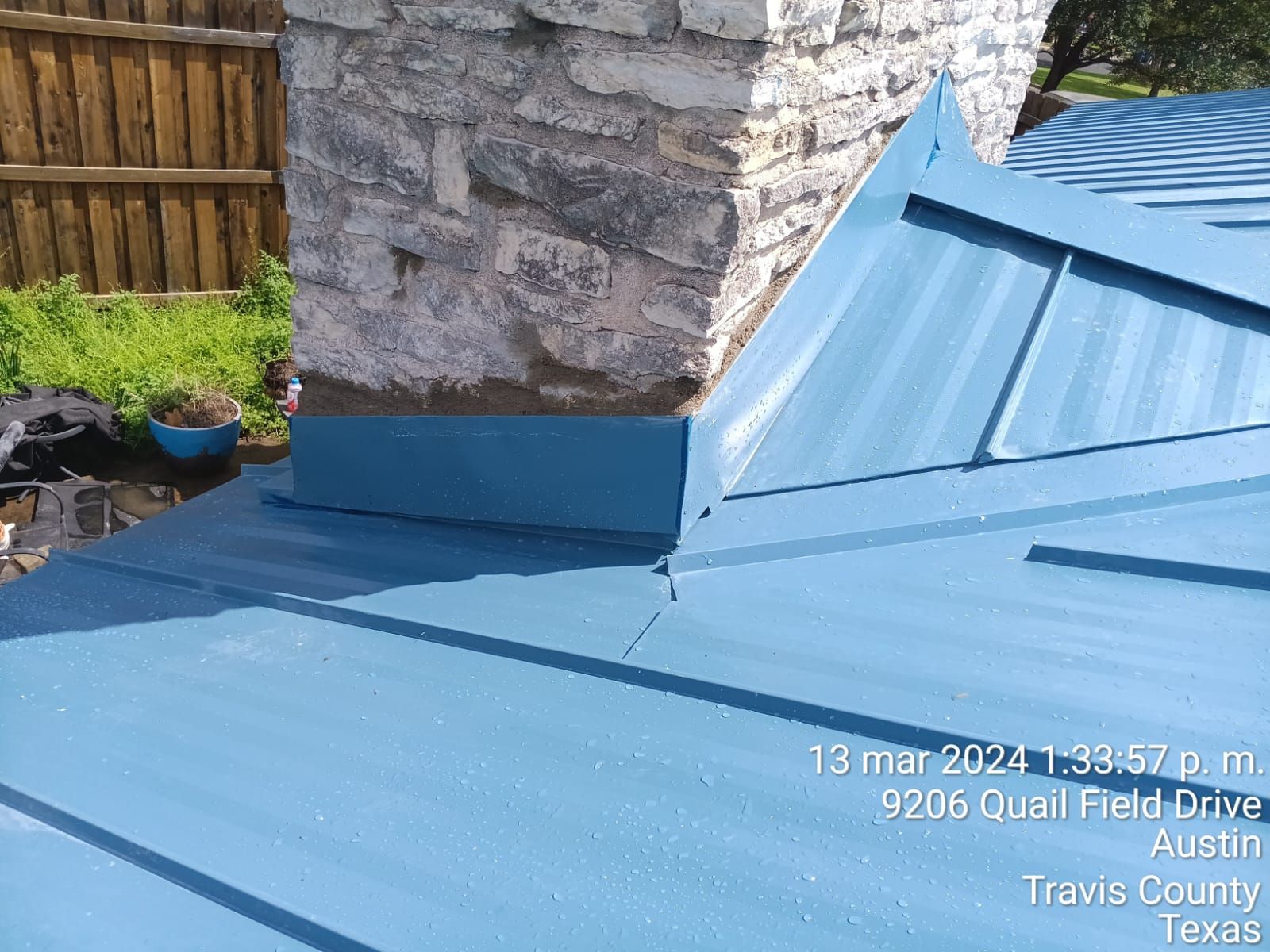 Metal roof panels meeting chimney flashing, Gold Coast Roofing and Solar
