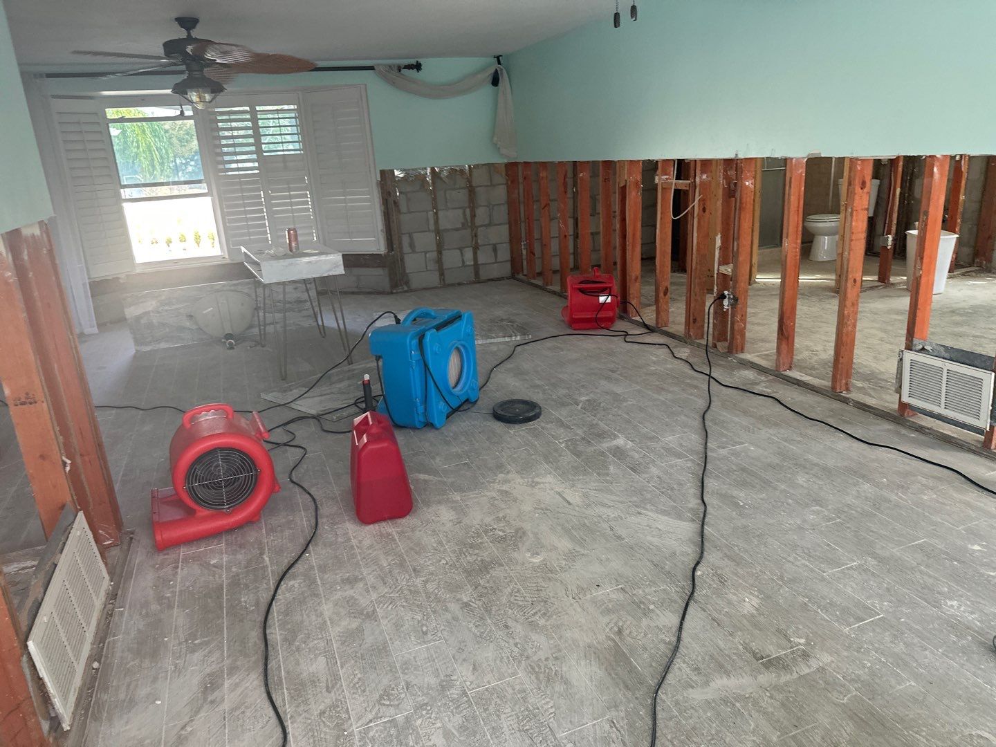 Drying equipment throughout a flood damaged living area