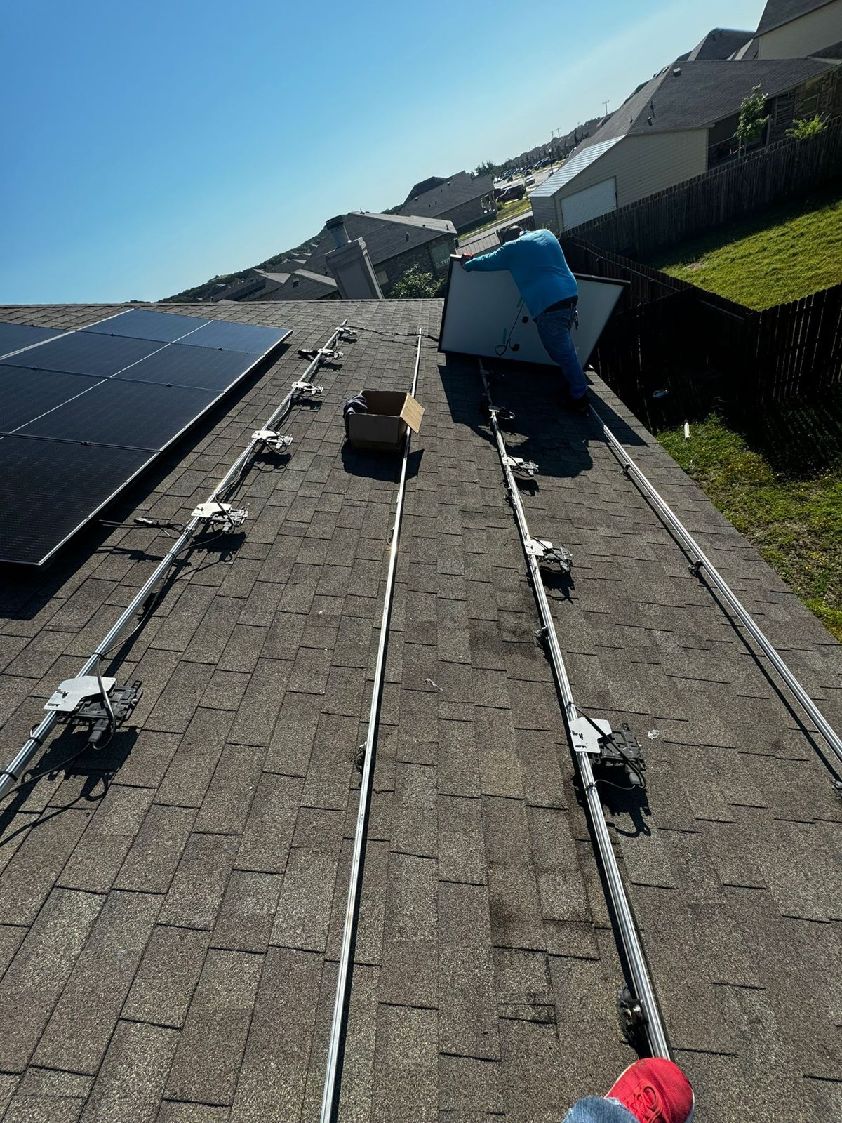 Racking rails and microinverters before panel install, military veteran solar project