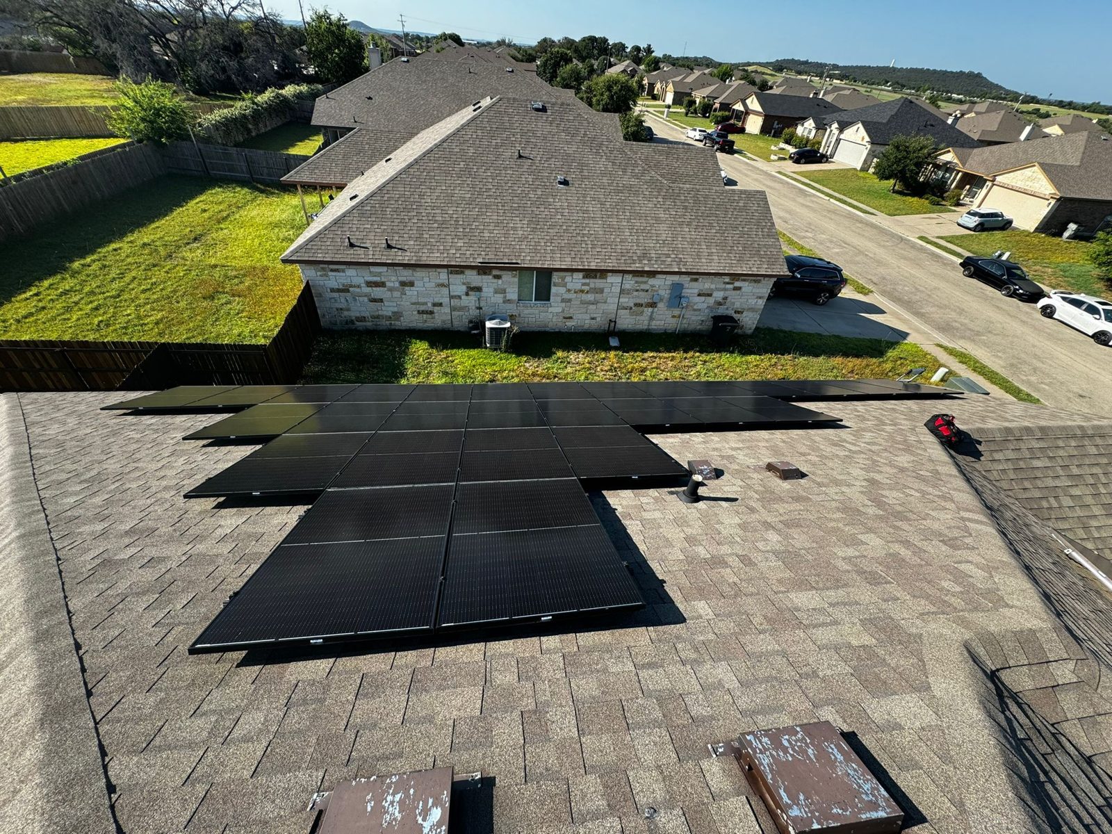 Finished residential solar array on a shingle roof, military veteran solar project